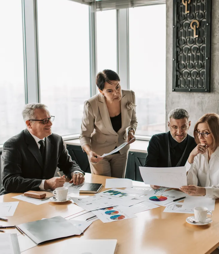 Business team reviewing reports and charts in a meeting